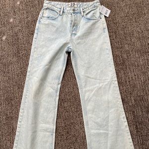 Light colored free people jeans with raw bottoms